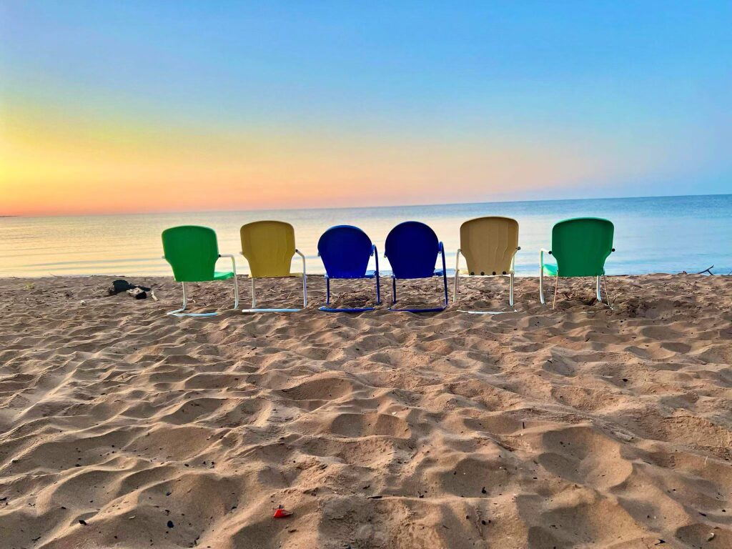 Beach chairs on the sand at Sandy Shores Cottages vacation rentals in Escanaba, Michigan